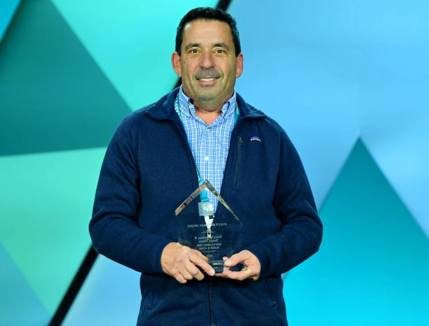 Rays Carpet One Floor & Home accepting the 2024 Wally Hileman Award from Carpet One