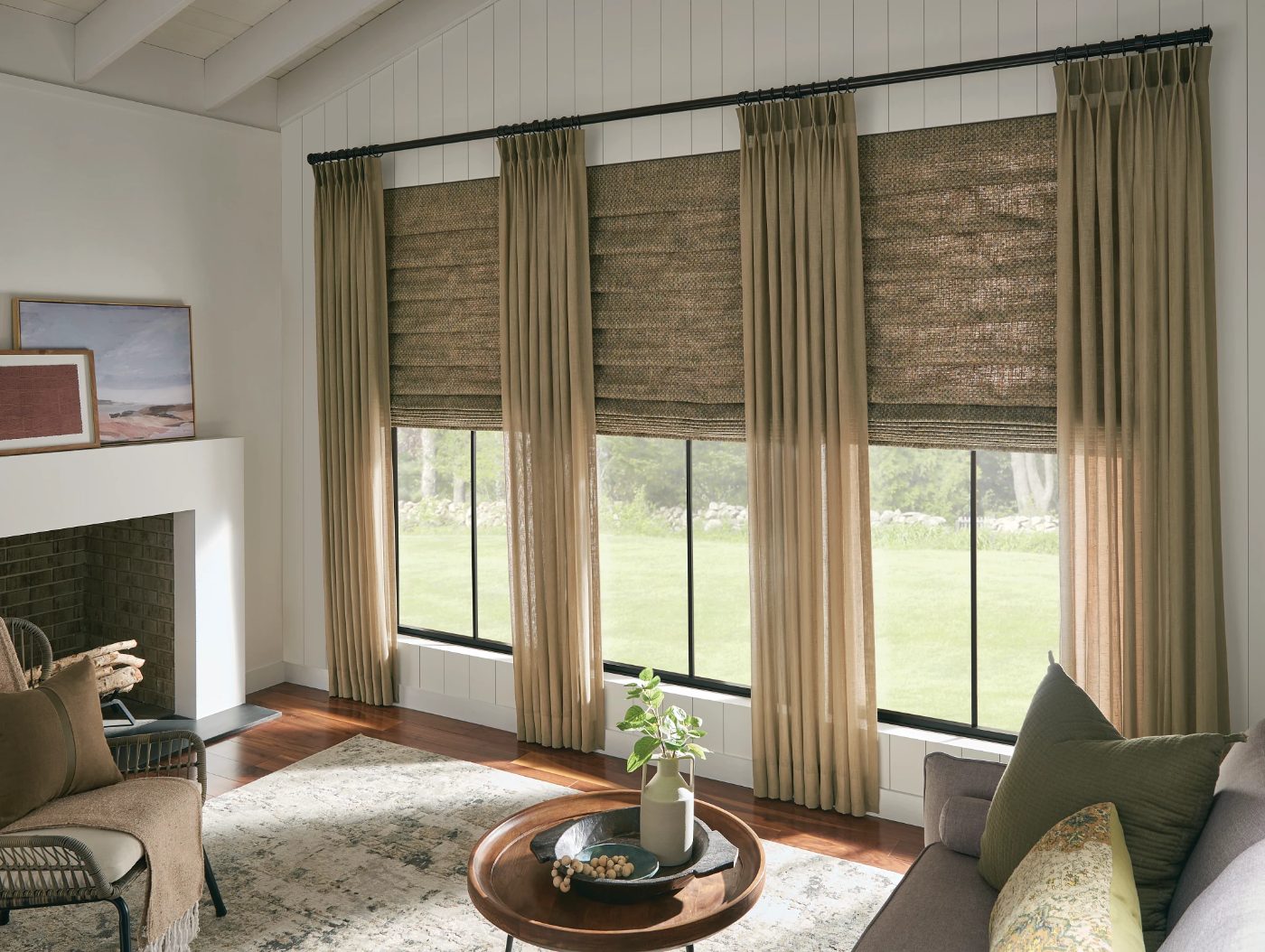 Graber Artisan sheer drapery and looped Roman shades in a living room
