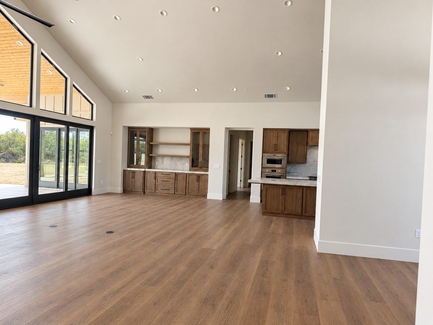 Open living area with wood-look floors in a new home