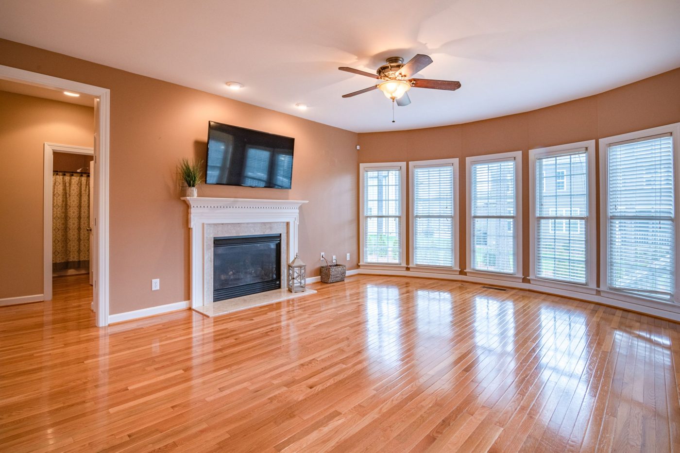 Bright living room with wood floors and a fireplace