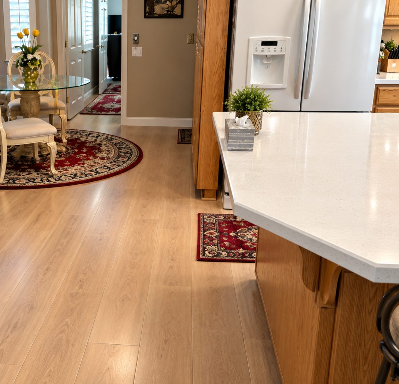 Light wood-look luxury vinyl plank in an open kitchen