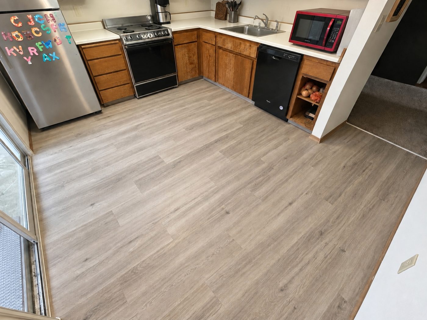 Gray wood-look luxury vinyl plank in a kitchen