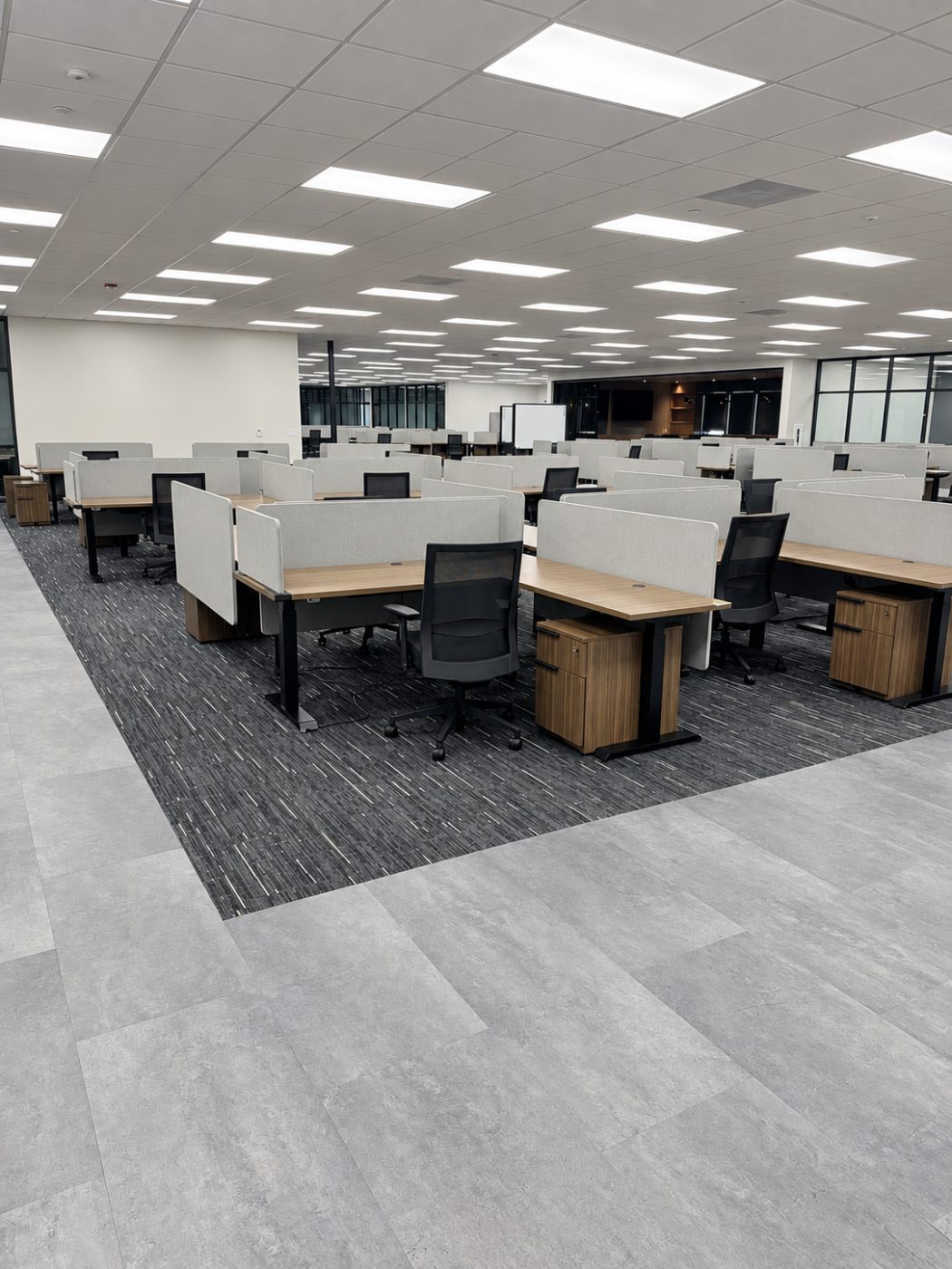Carpet tile and stone-look luxury vinyl plank in an open office