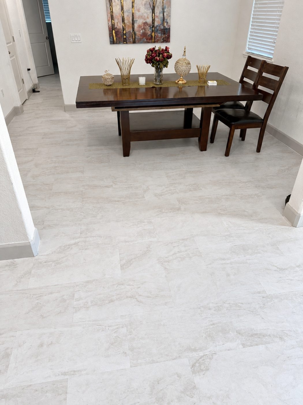 Large-format stone-look luxury vinyl plank in a dining room