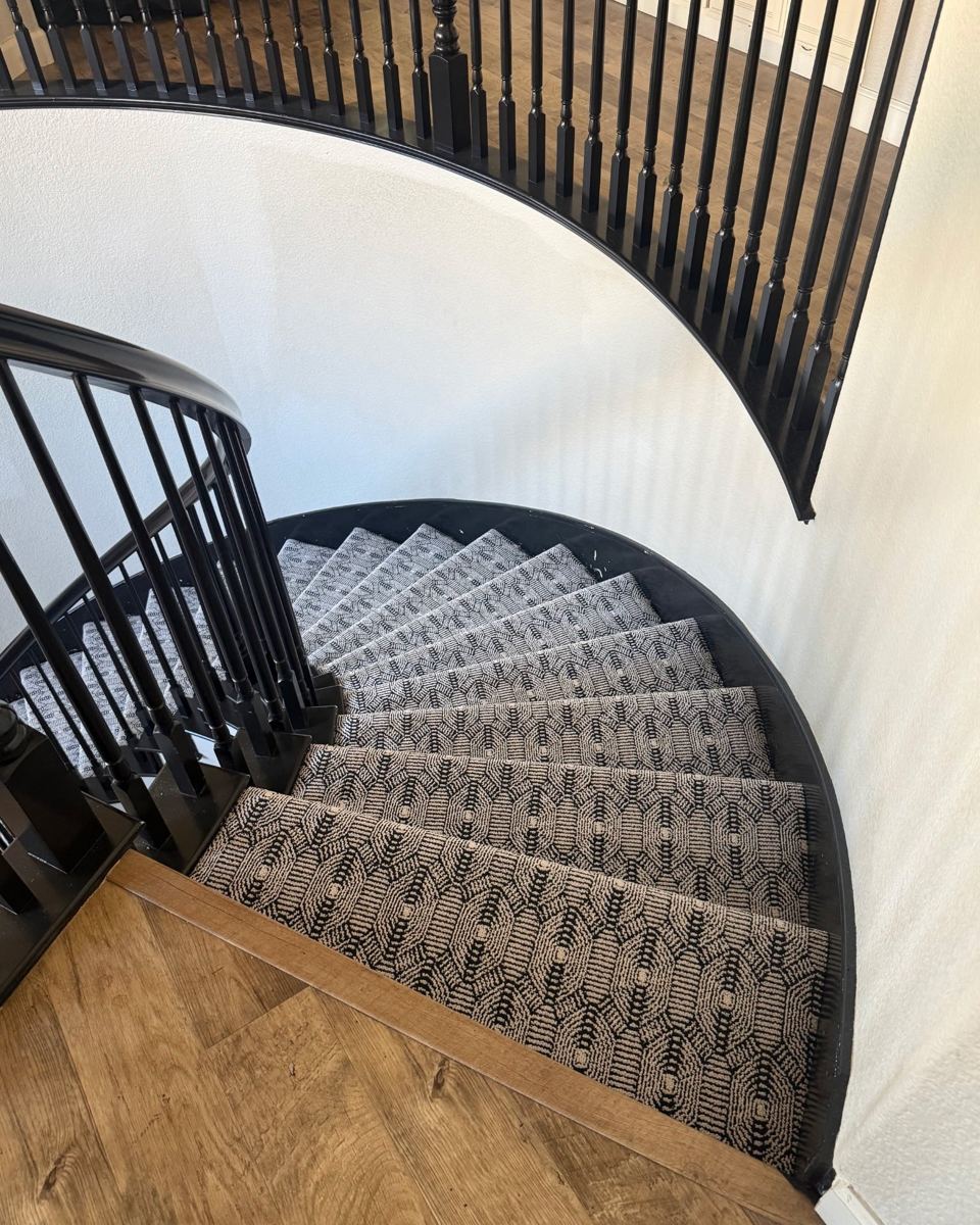 Looking down a curved staircase with Karastan Whitemere patterned carpet